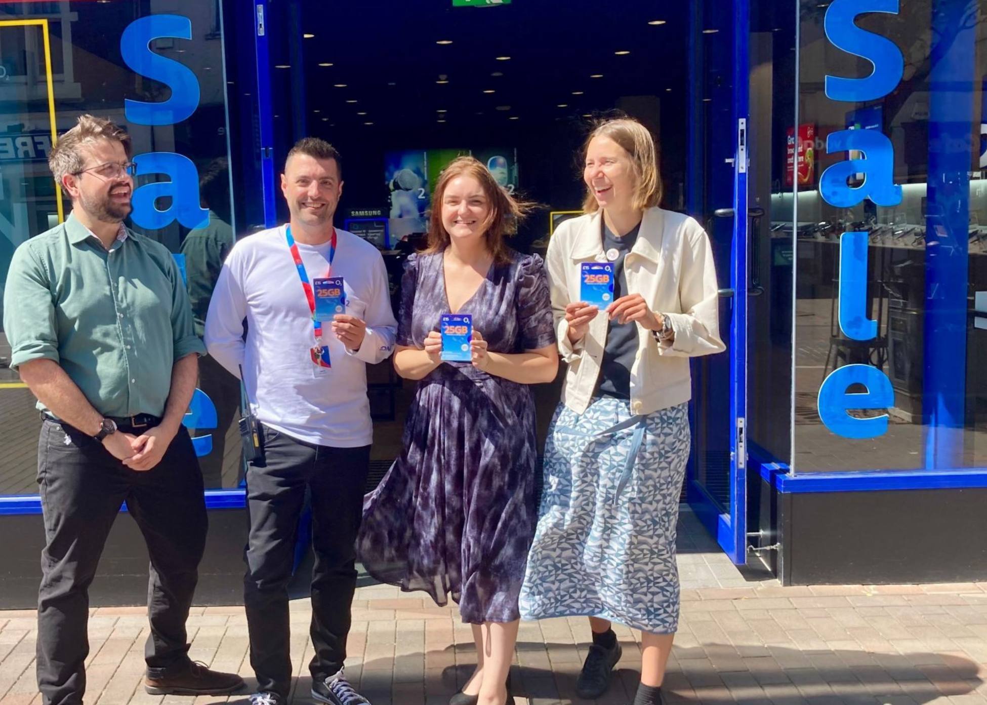 A group of people standing outside the O2 store in Stafford.