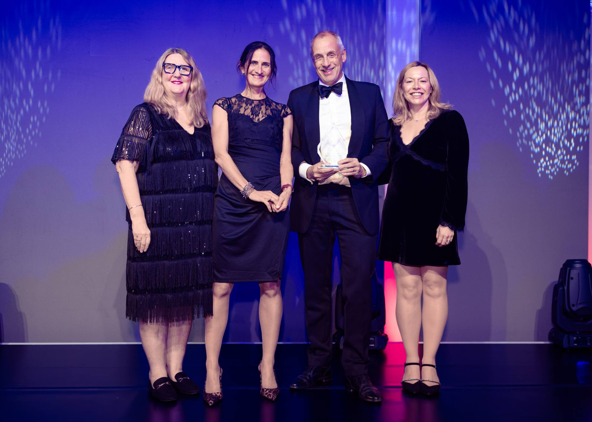 Three people with Good Things Foundation CEO Helen Milner OBE.